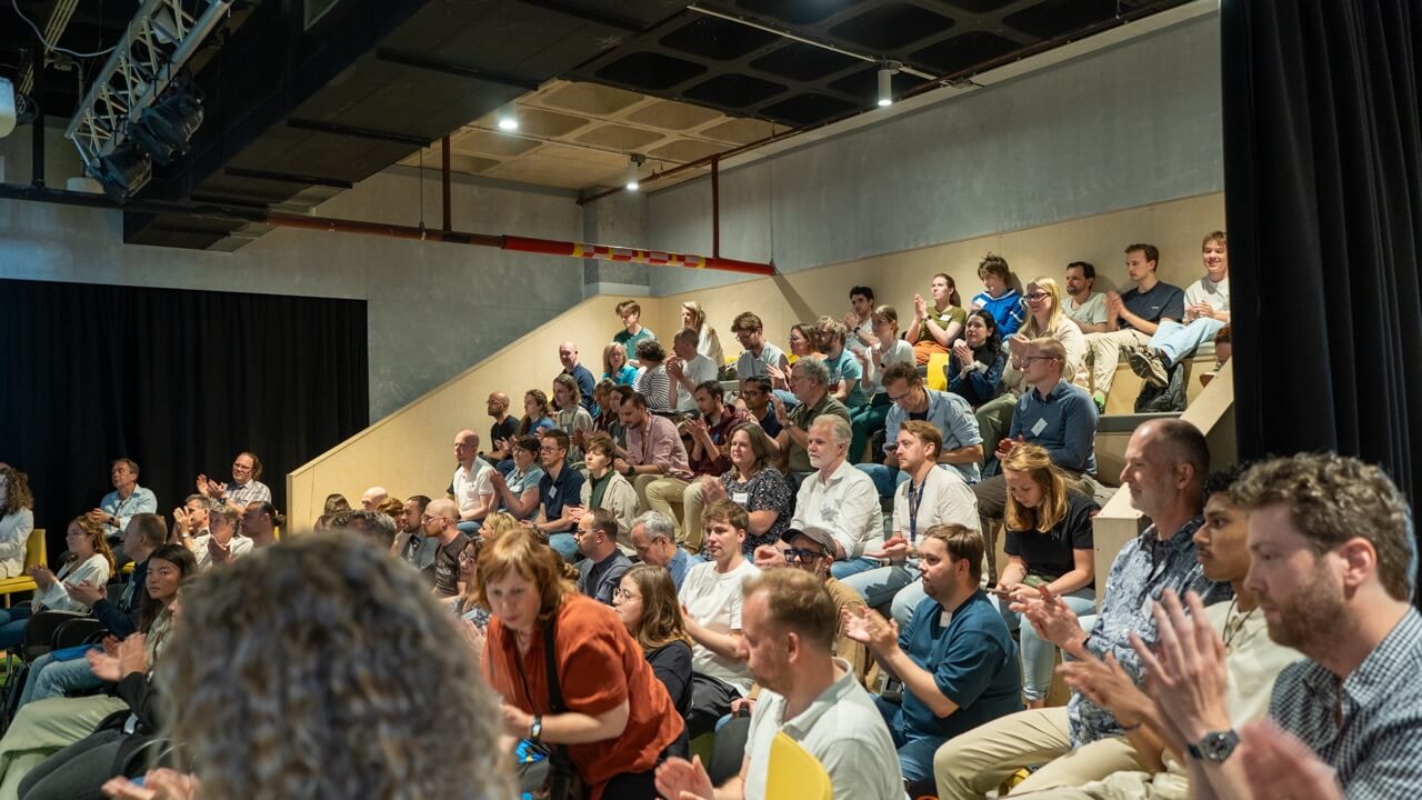 Attendees clapping during the presentations